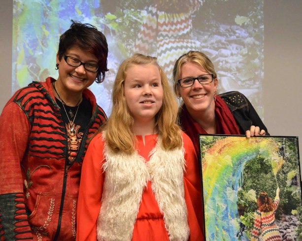 Ivy Tech Northeast visual communications major Colene Smart joins Hannah Hubley, 13, and her mother, Rebekah Hubley, for a class presentation. Smart worked with the Hubleys on an art project that put Hannah, who is blind, into a fantasy setting based on Hannah’s interests. Smart’s finished piece graces the cover of this issue.